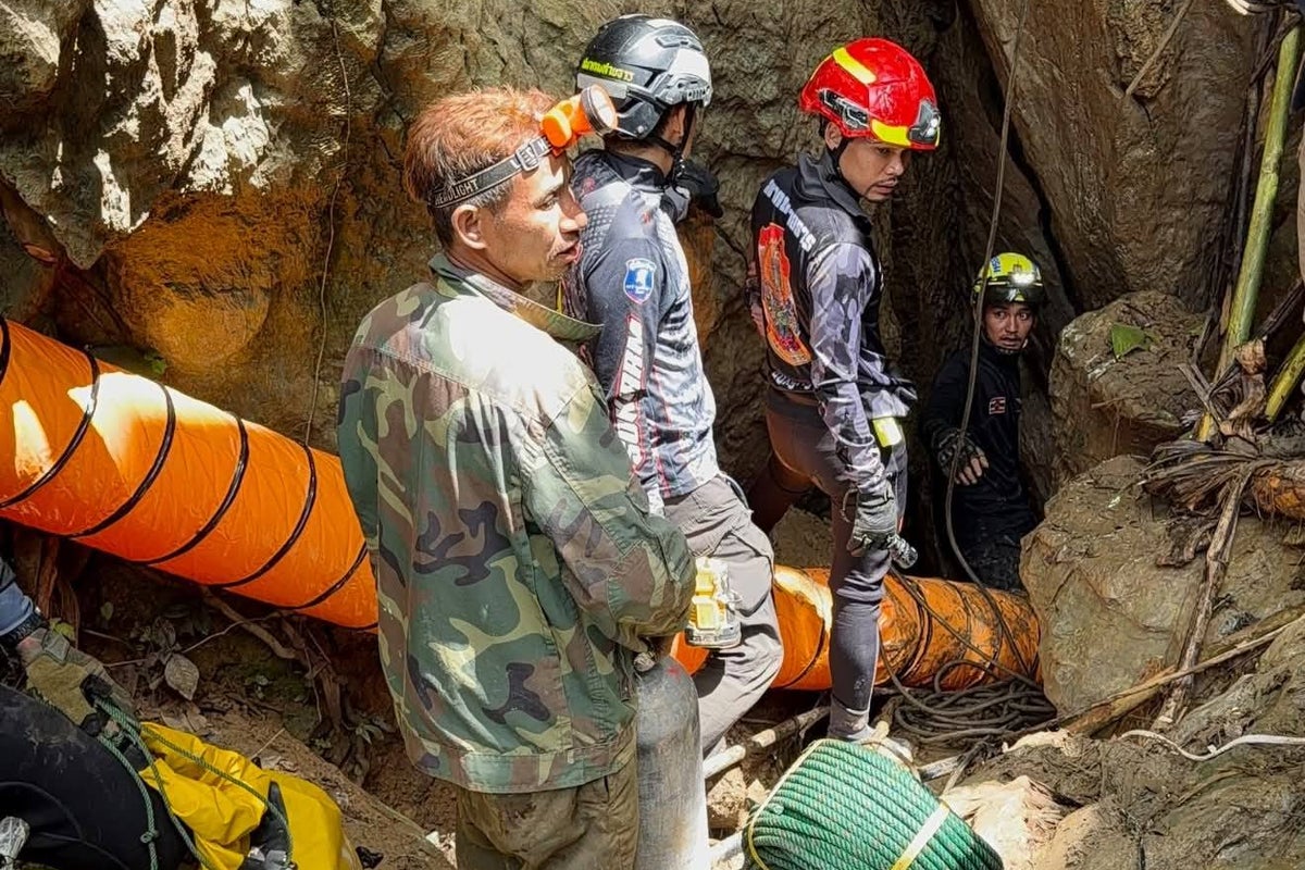 Rescuers race to reach 7 trapped in a Laos cave after flash floods block exit